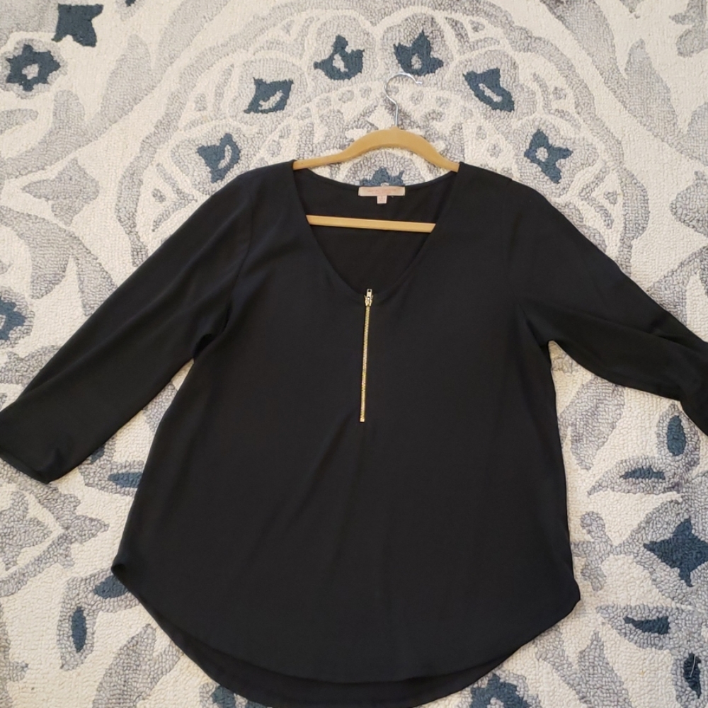 Black top with gold zipper detail